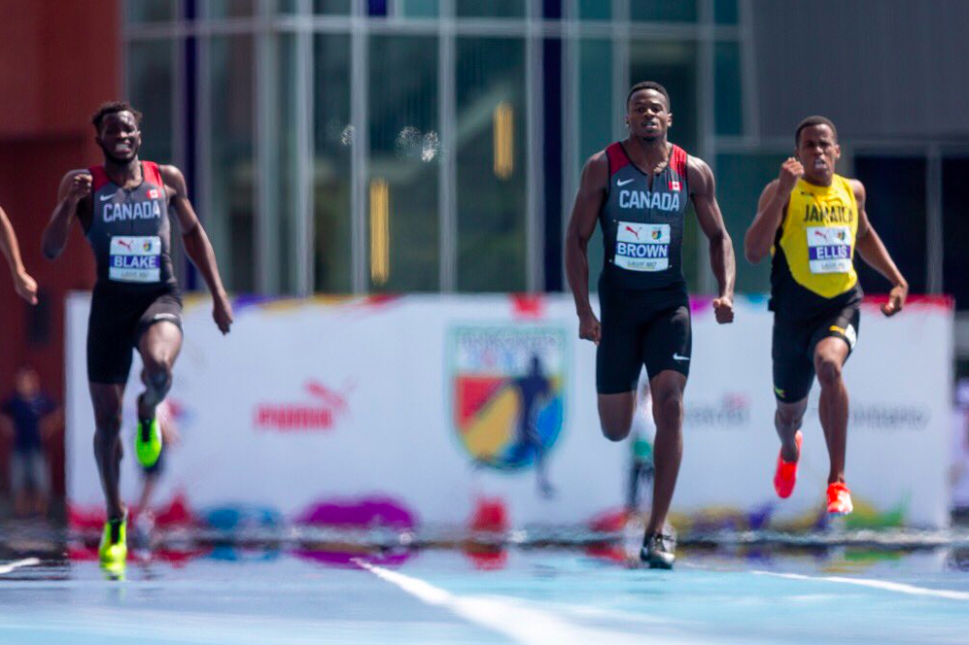 Aaron Brown, au centre, lors de la finale du 200 m masculin aux Championnats NACAC de Toronto, le 12 août 2018. COC/Crystal Emmanuel porte le drapeau canadien après avoir remporté la médaille d'argent au 200 m, aux Championnats NACAC, à Toronto, le 12 août 2018. COC/Thomas Skrlj