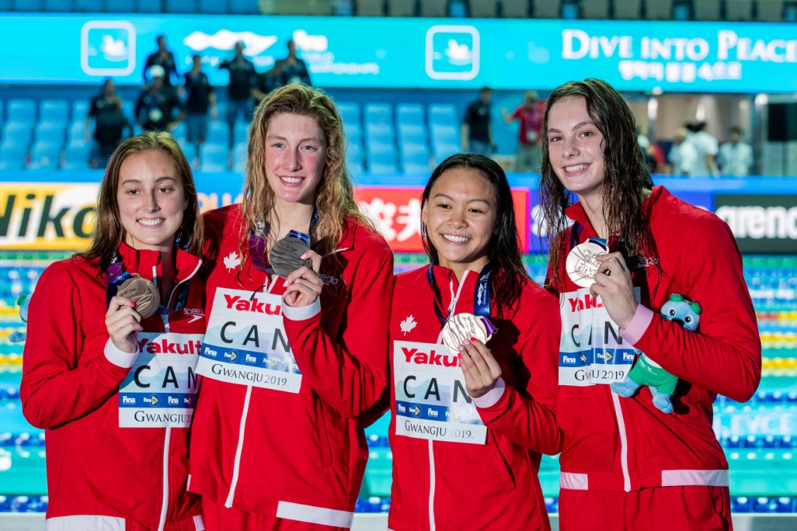 Quatre nageuses canadiennes posent avec leurs médailles.
